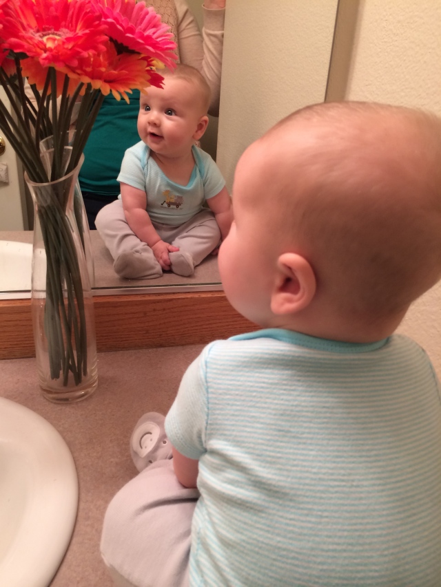 Baby dude sitting up on the bathroom counter, with no help from mama! He's getting there, can't quite trust him to not tip over yet though :)